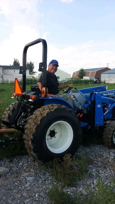 Bobby on his tractor at the farm